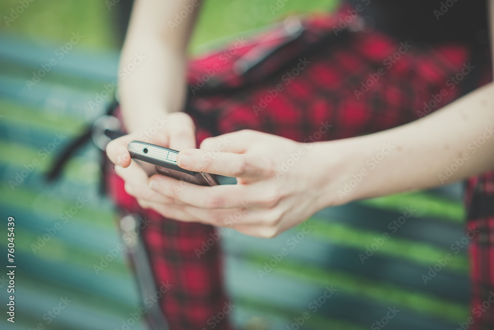 Close up of woman's hands using smartphone outdoors