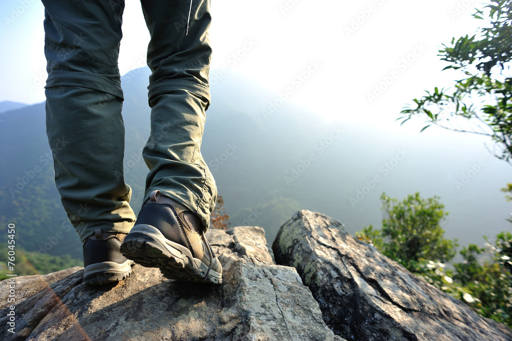 woman hiker stand on mountain peak rock woman hiker stand on mountain peak rock