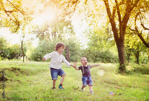 Little boys having fun on a meadow