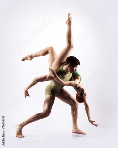 Couple of gymnasts on a light grey background photo