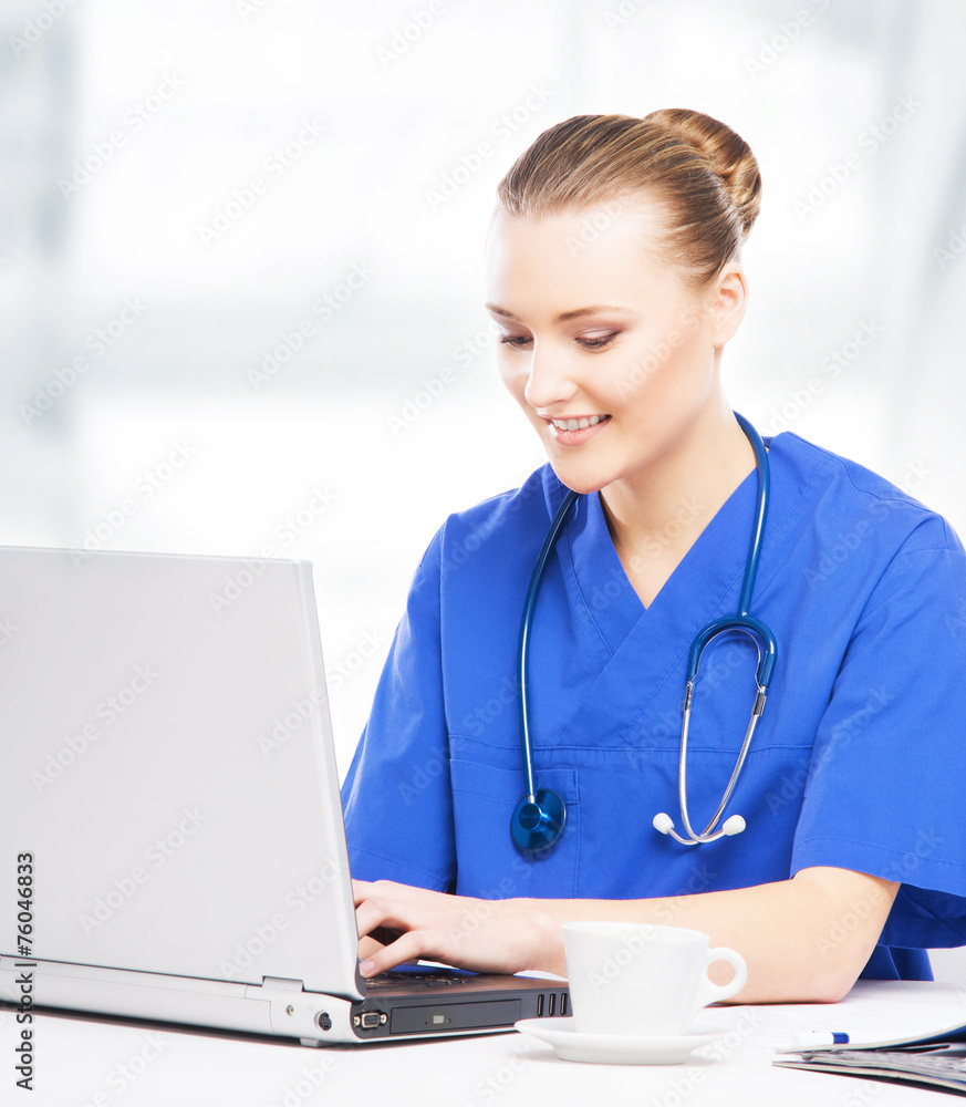 Young, professional and cheerful female doctor working in office Young, professional and cheerful female doctor working in office