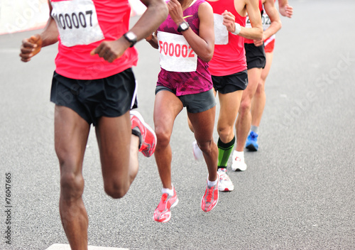  marathon athletes legs running on city road