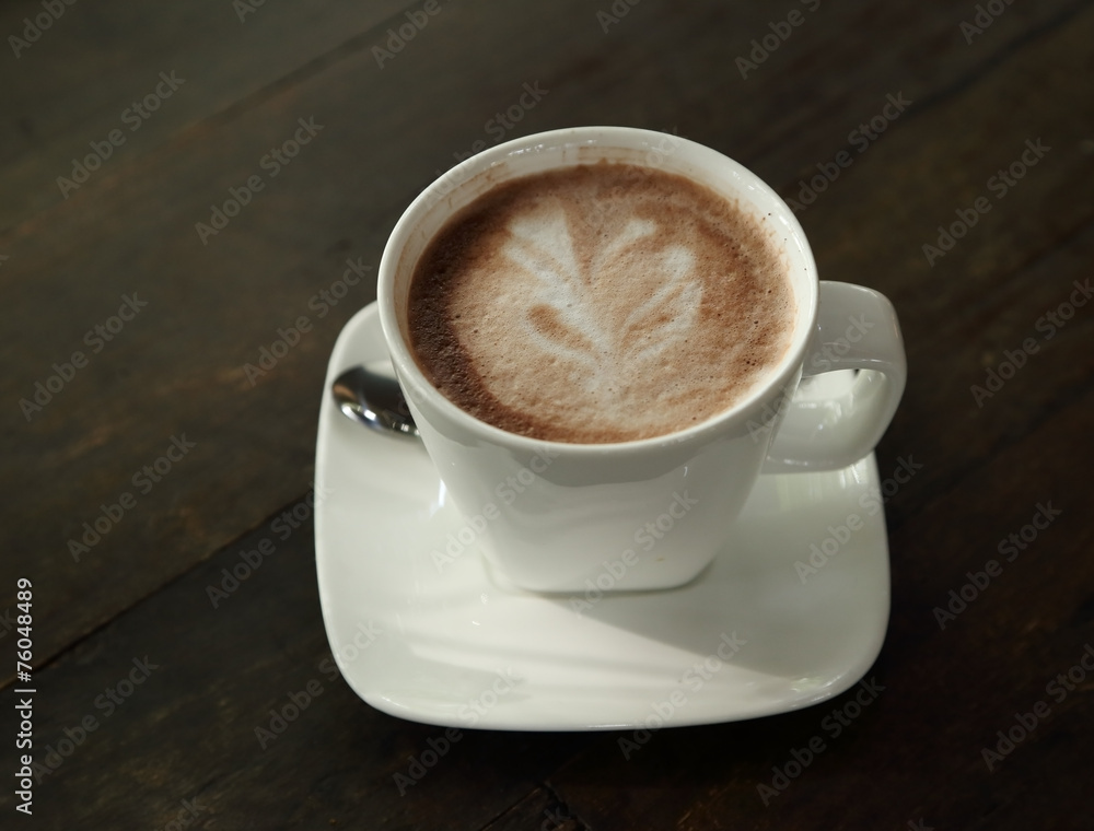 Hot chocolate in a white cup on table Hot chocolate in a white cup on table
