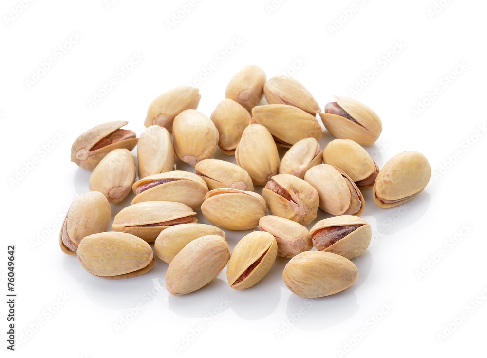 toasted pistachios on a white background toasted pistachios on a white background