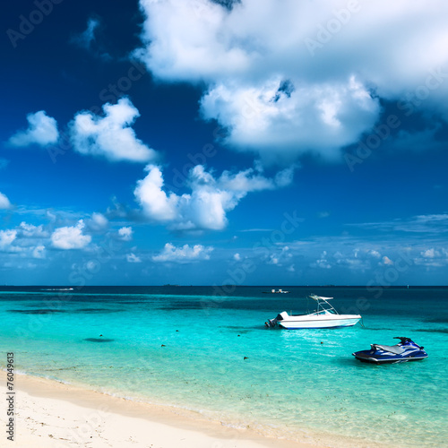 Beautiful island beach with motor boat