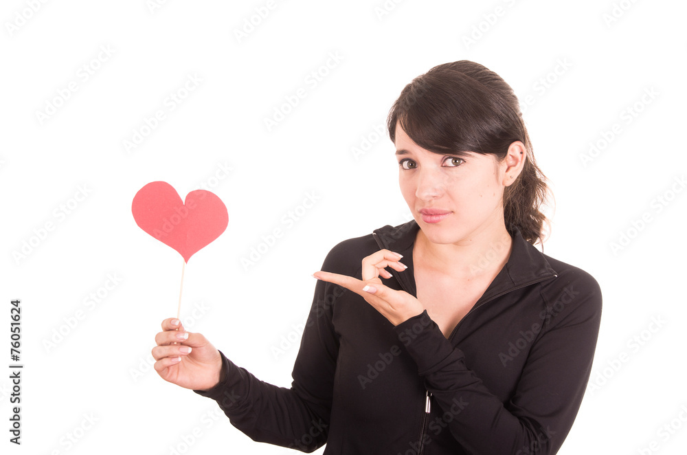 beautiful young latin girl pointing confused at red paper heart beautiful young latin girl pointing confused at red paper heart