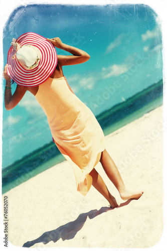 woman in colorful dress walking on beach ocean