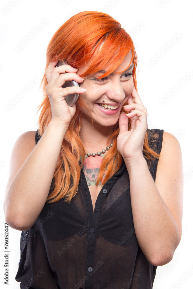 Pretty redhead girl laughing into the mobile