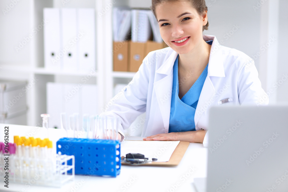 Woman researcher is surrounded by medical vials and flasks Woman researcher is surrounded by medical vials and flasks