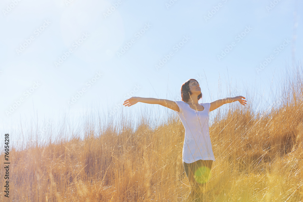 happy girl in field of tall grass golden