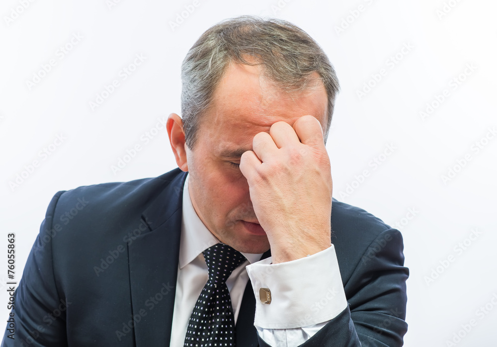Frustrated businessman holding head in his hands Frustrated businessman holding head in his hands