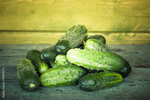 Some fresh cucumbers on a wooden board