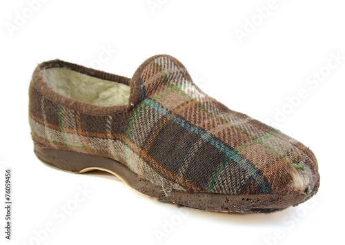 Old slippers with a hole on white background.