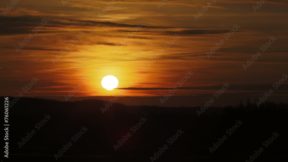 The sunset (sunrise) above the foggy field and village The sunset (sunrise) above the foggy field and village