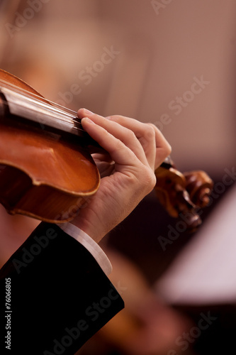 Musician hand on the fingerboard violin