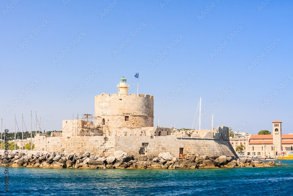 Old fortress with lighthouse in the port of Mandraki. Rhodes Isl
