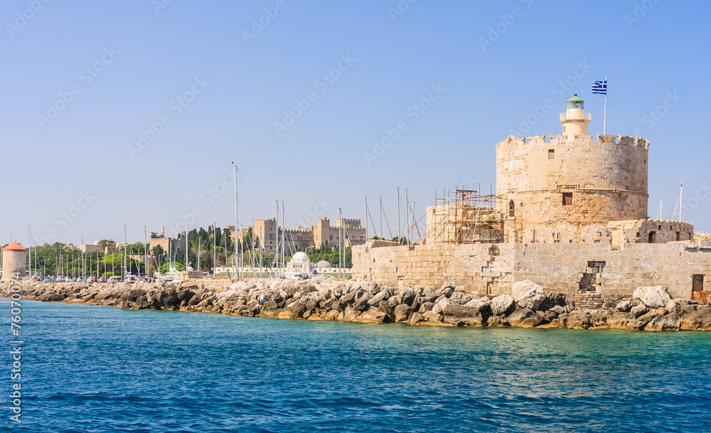 Old fortress with lighthouse in the port of Mandraki. Rhodes Isl