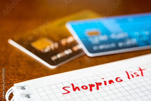 Shopping list, a notebook with shopping list and a credit cards