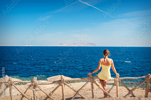 woman sitting looking at the sea