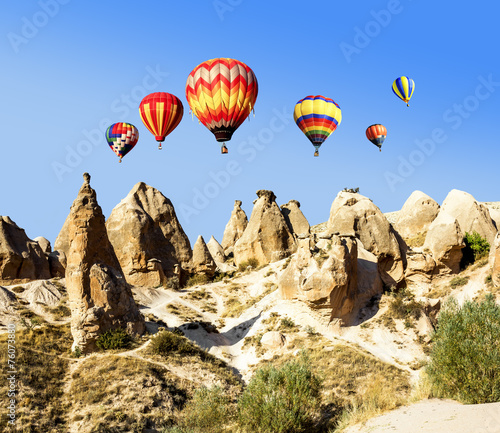 Balloons over the volcanic mountain landscape of Cappadocia