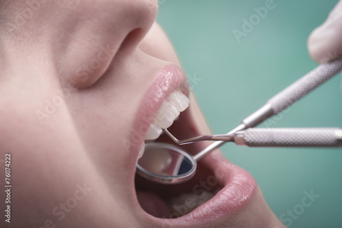 Young woman and dental instrument