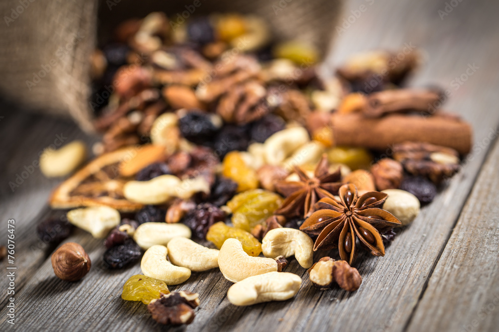 Close-up of nuts and dried fruits mix on wooden surface. Close-up of nuts and dried fruits mix on wooden surface.