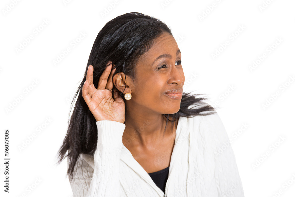 unhappy hard of hearing woman placing hand on ear unhappy hard of hearing woman placing hand on ear
