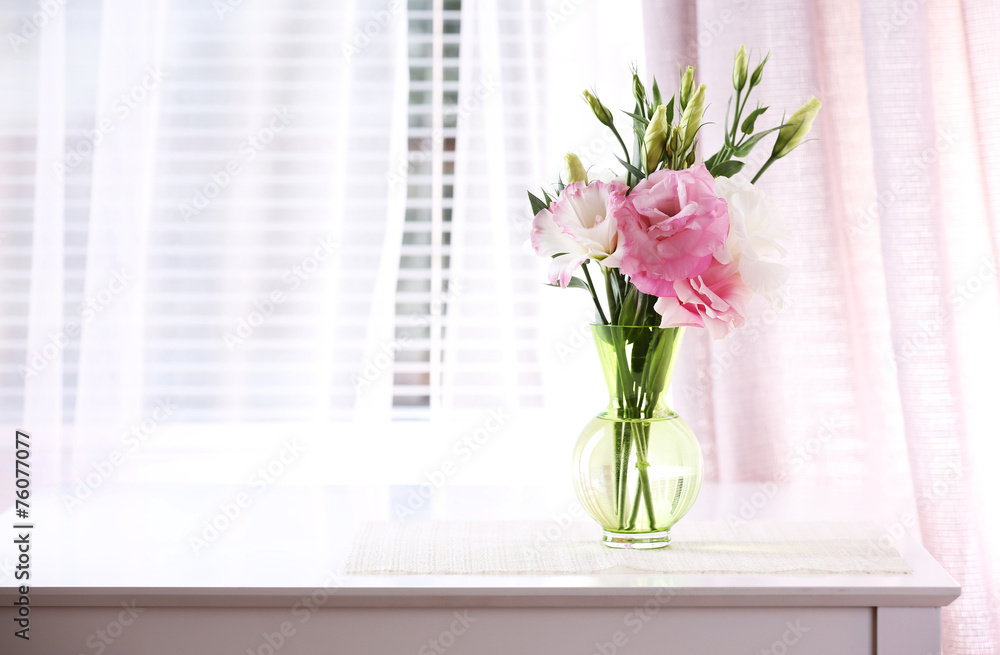 Fototapeta premium Beautiful flowers in vase with light from window