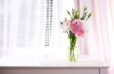 Beautiful flowers in vase with light from window