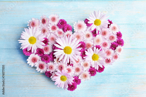 Fototapeta Naklejka Na Ścianę i Meble -  Beautiful flowers in heart shape on wooden background