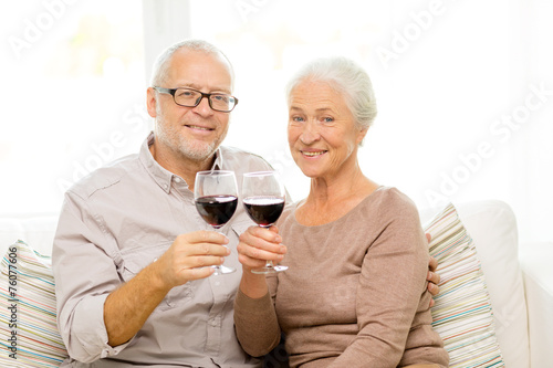 happy senior couple with glasses of red wine