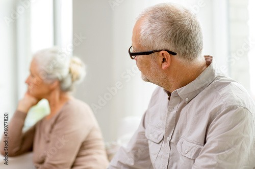 senior couple sitting on sofa at home