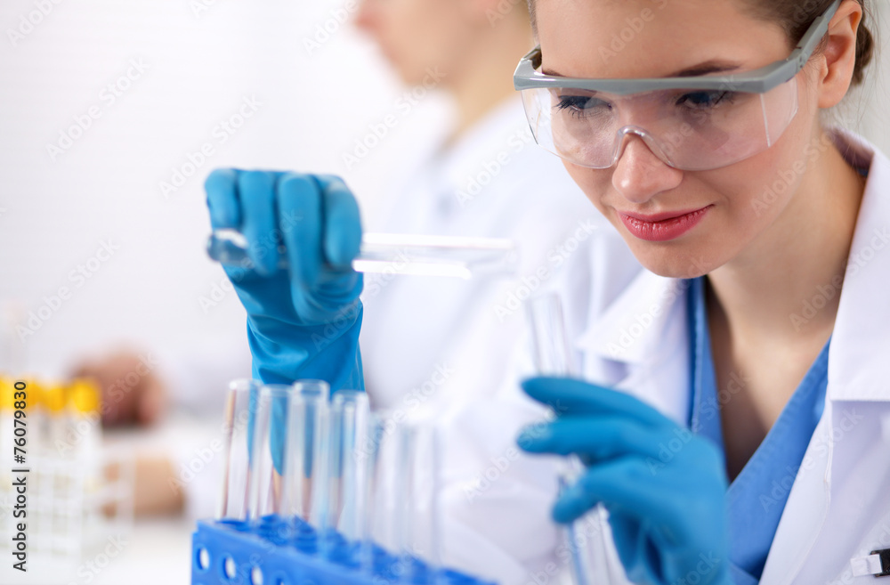 Woman researcher is surrounded by medical vials and flasks, Woman researcher is surrounded by medical vials and flasks,