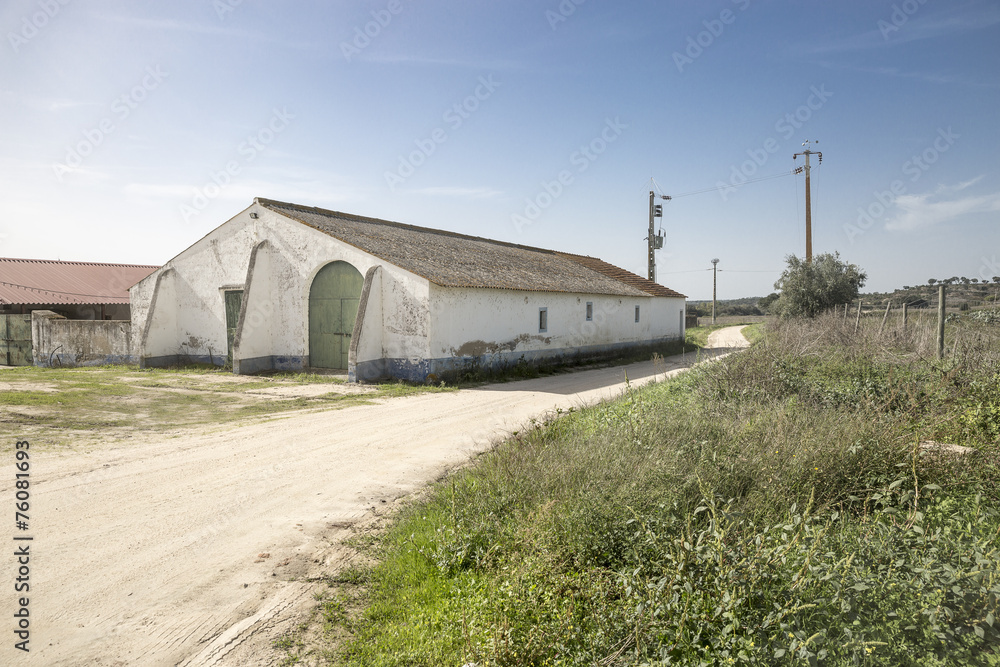 warehouse and a rural dirt road in the countryside warehouse and a rural dirt road in the countryside