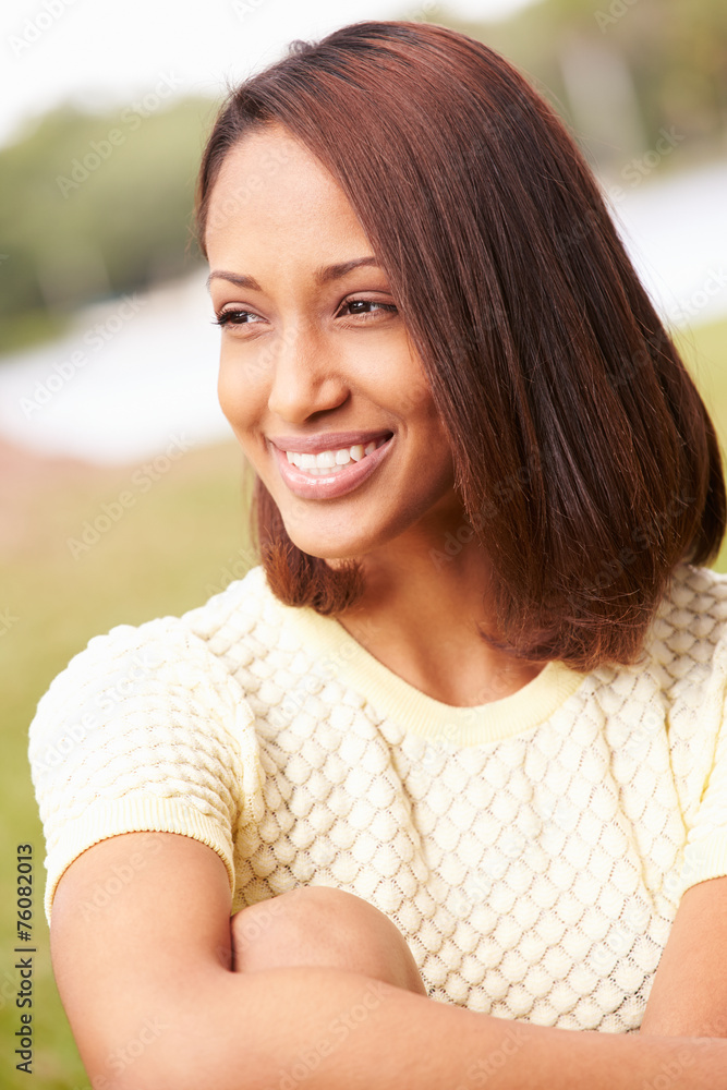 Portrait Of Pretty Young Woman Sitting In Garden Portrait Of Pretty Young Woman Sitting In Garden