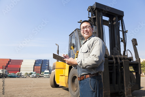 happy stacker driver writing on a document