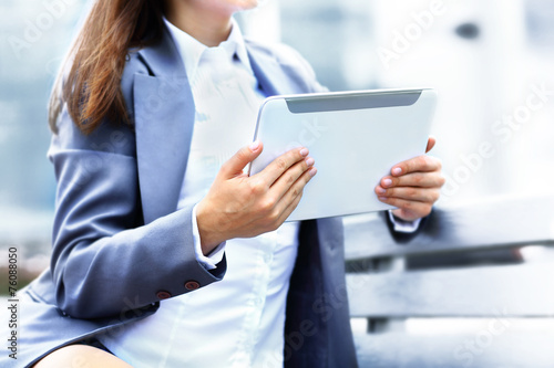 Successful businesswoman or entrepreneur using a digital tablet