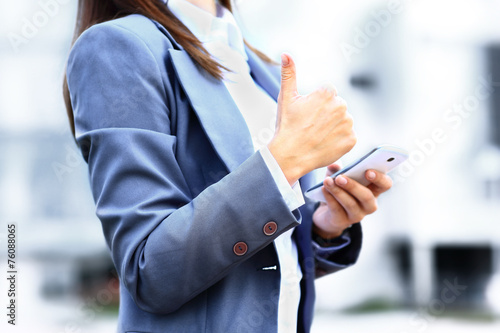 Pretty young business woman using mobile phone