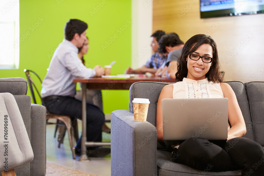 Woman Sitting On Sofa And Working In Design Studio Woman Sitting On Sofa And Working In Design Studio