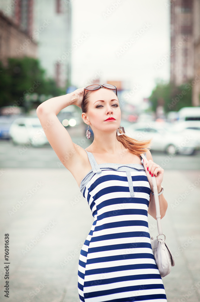 Young beautiful fashionable woman in the city