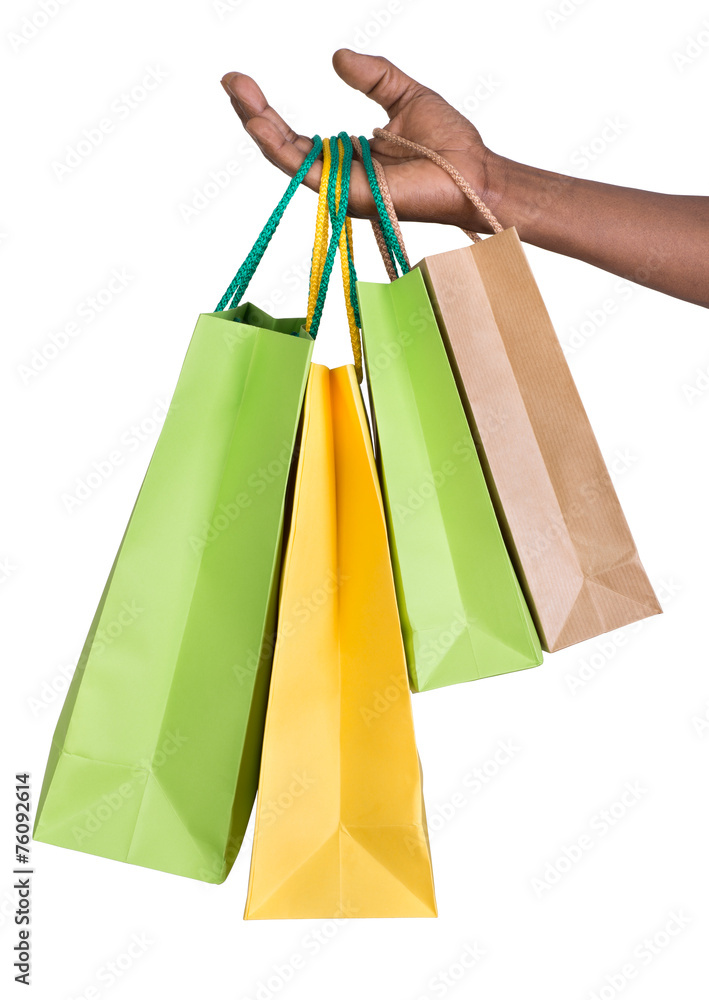 Male hand holding shopping bags isolated on white