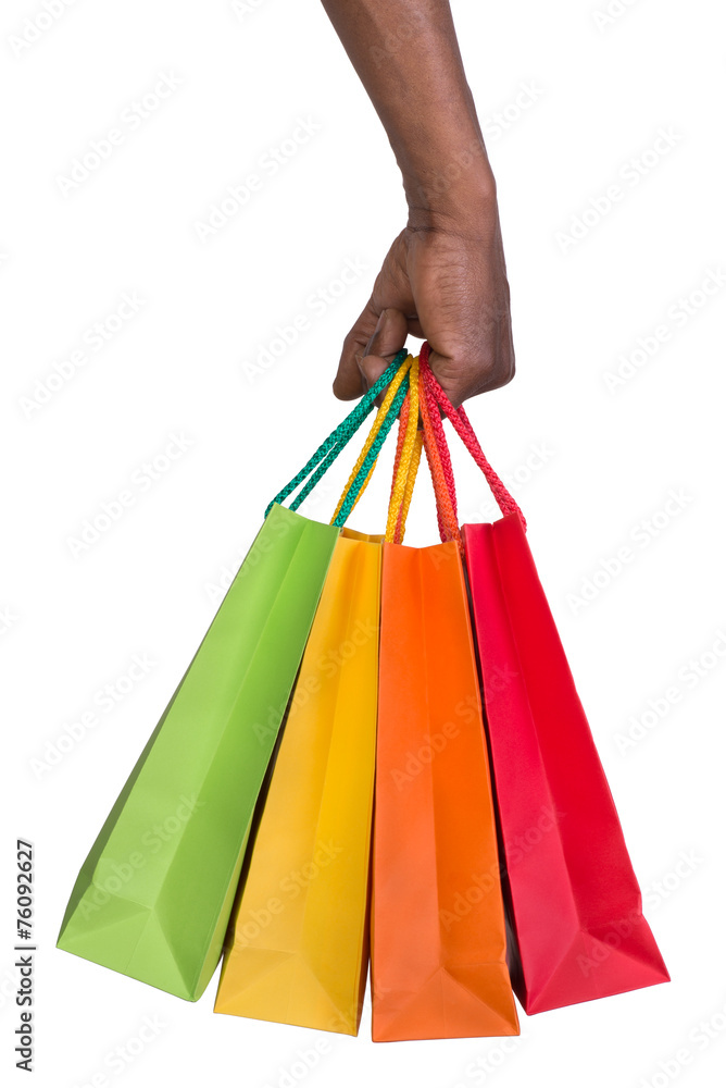 Male hand holding shopping bags isolated on white
