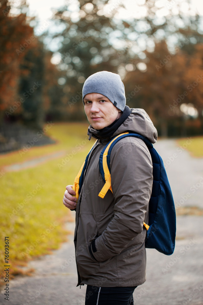 Fototapeta premium portrait of the young man with a backpack in outdoor