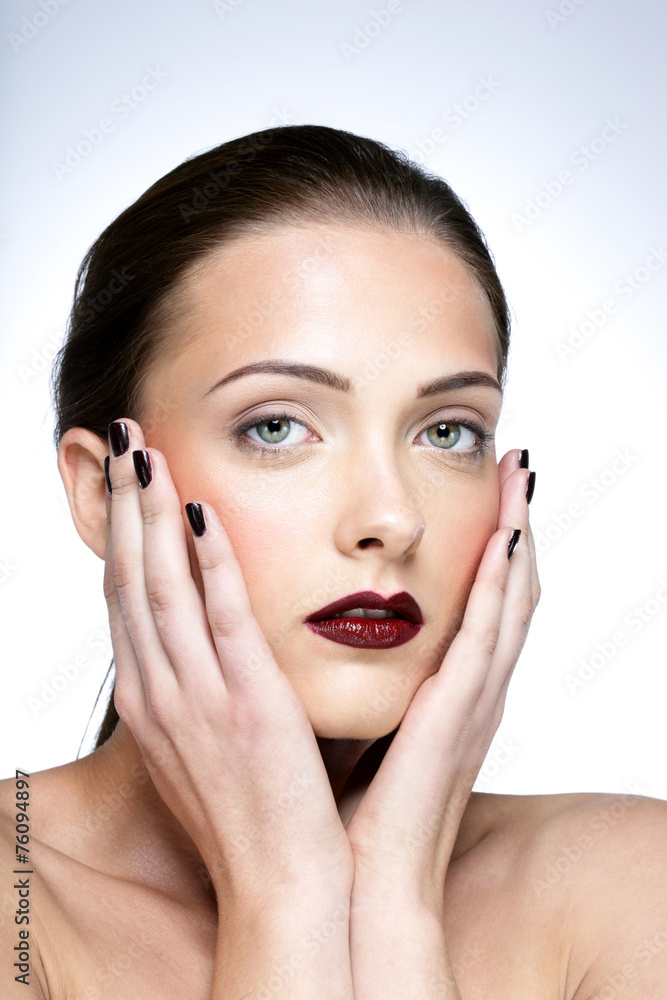 Beauty portrait of a cute woman touching her face