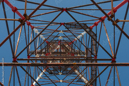 High-voltage tower against blue sky.