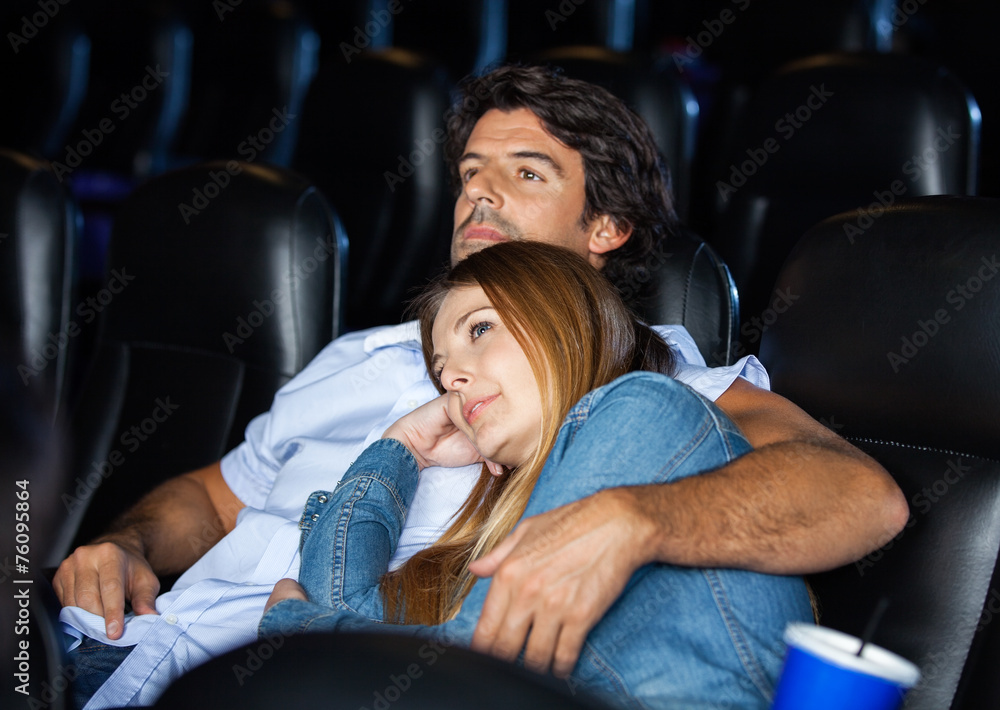 Fototapeta premium Loving Couple Watching Movie In Theater