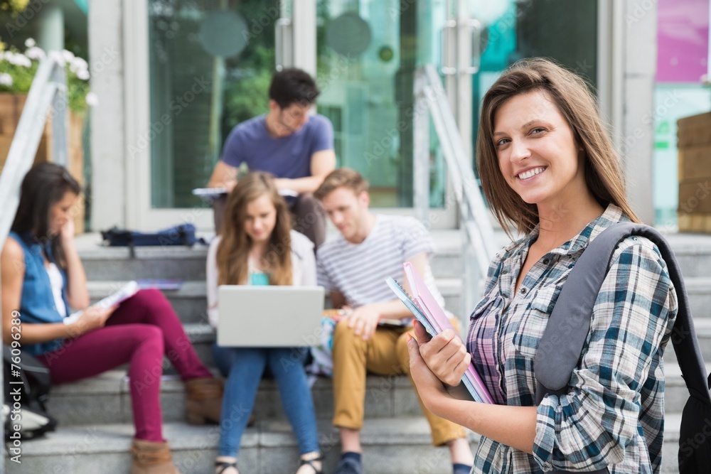 Pretty student smiling at camera outside Pretty student smiling at camera outside