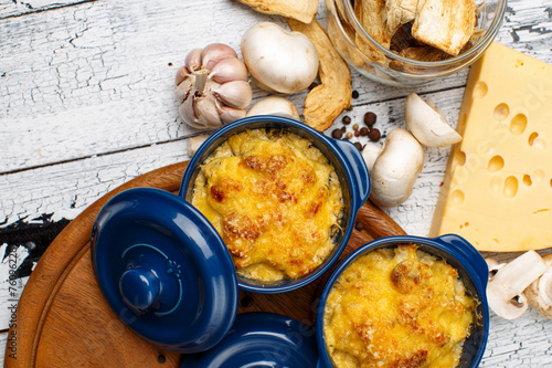 Moshroom casserole in a blue ceramic pot photo