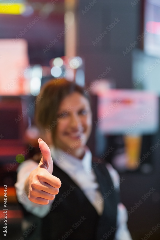Barmaid showing thumbs up to camera Barmaid showing thumbs up to camera