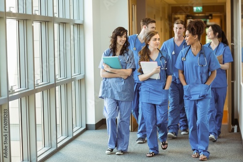 Medical students walking through corridor photo